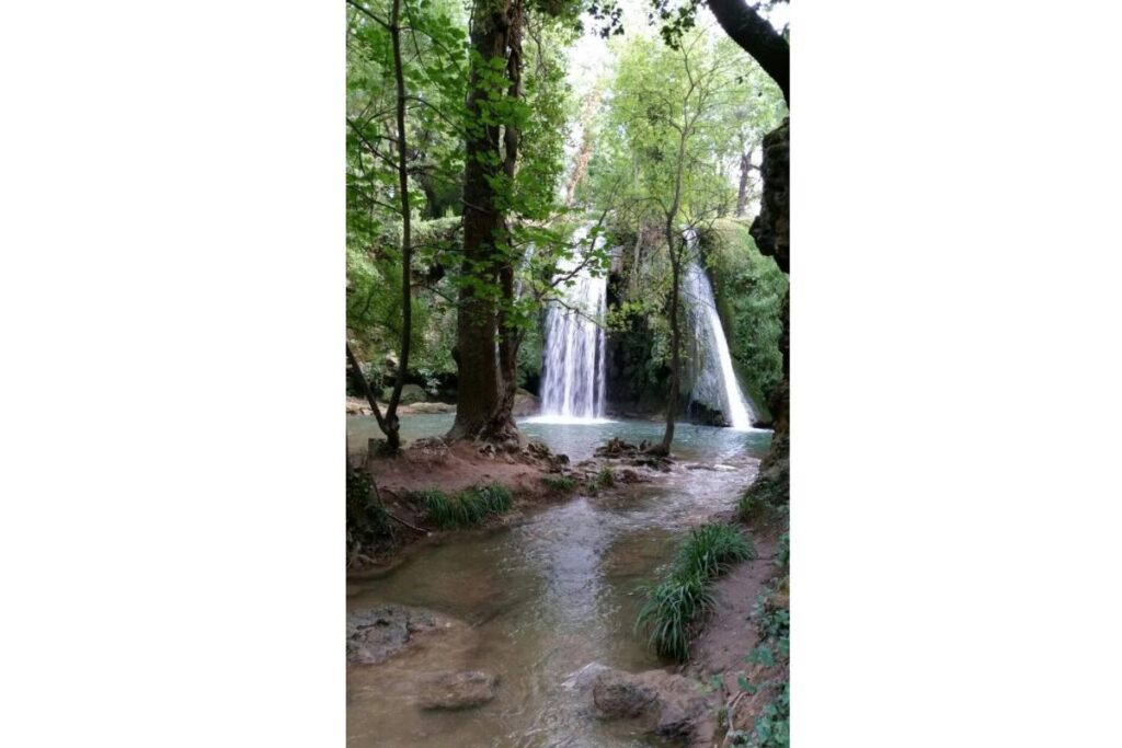 Sentier caillouteux traversant la garrigue et les pins vers la cascade du Grand Baou, Vaucluse