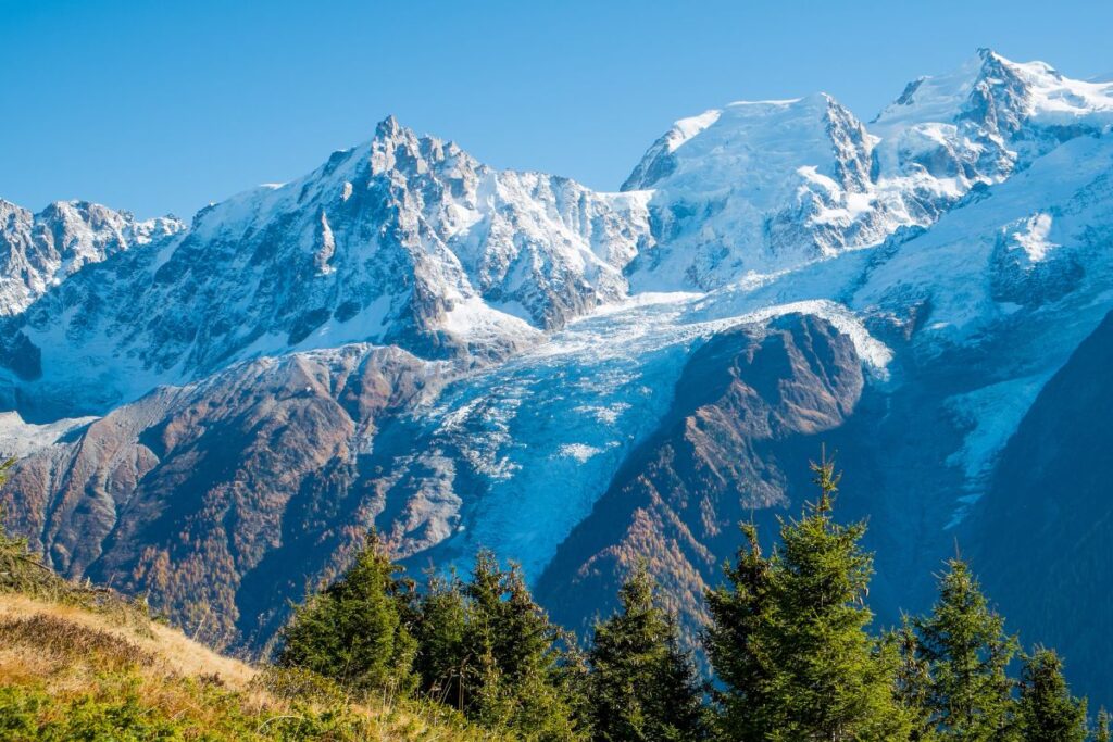Vététiste sur un sentier de montagne face au massif du Mont-Blanc